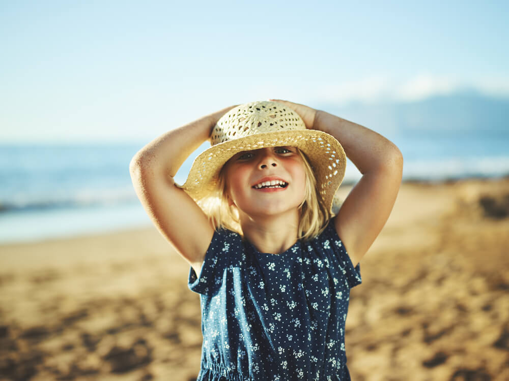 Picture of child in sunhat at the beach