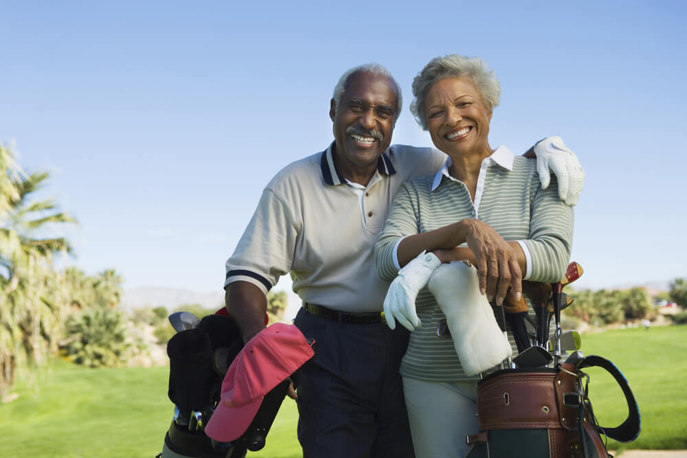 mature couple playing golf