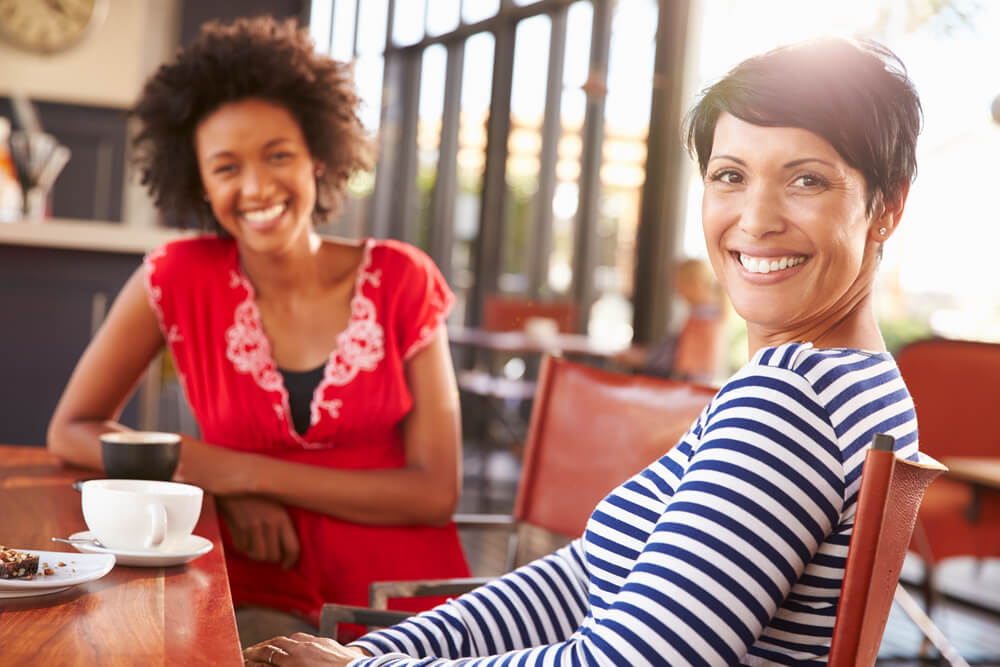 Two women having coffee together