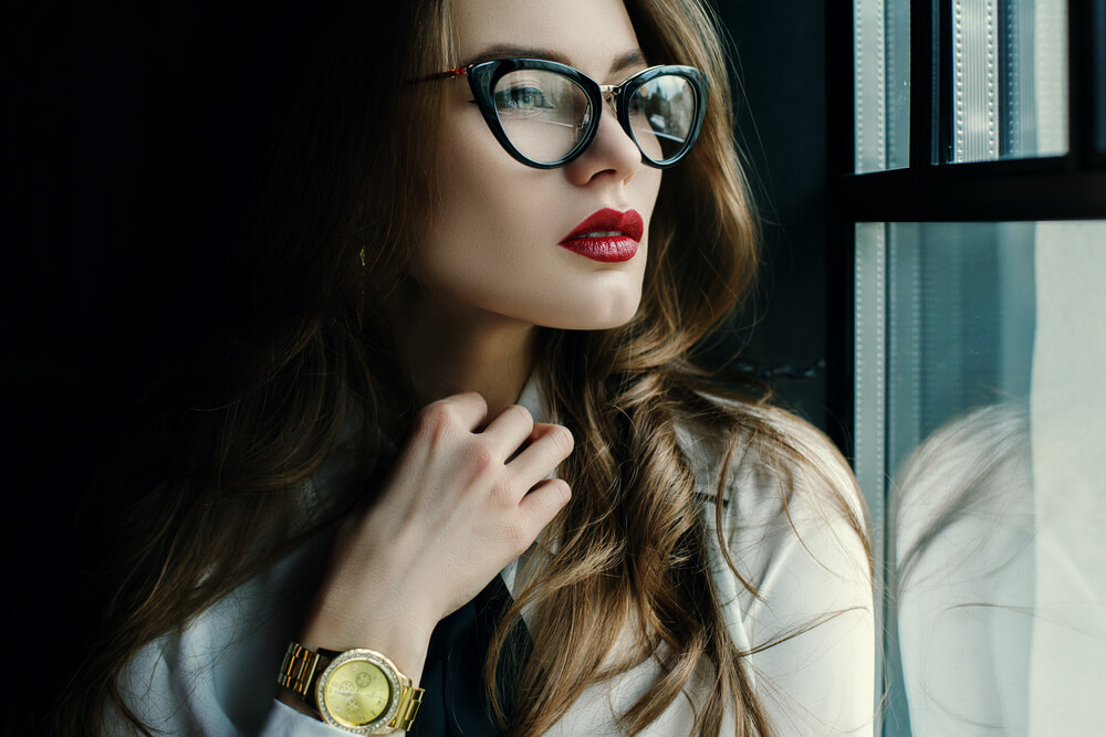 Beautiful young woman in stylish glasses